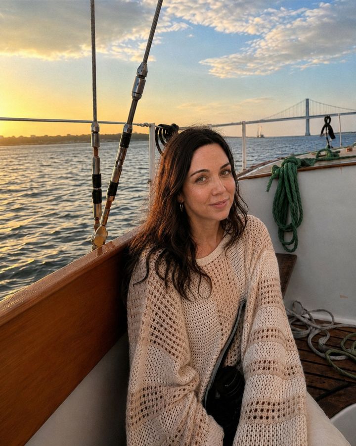 Anna aboard a boat at sunset